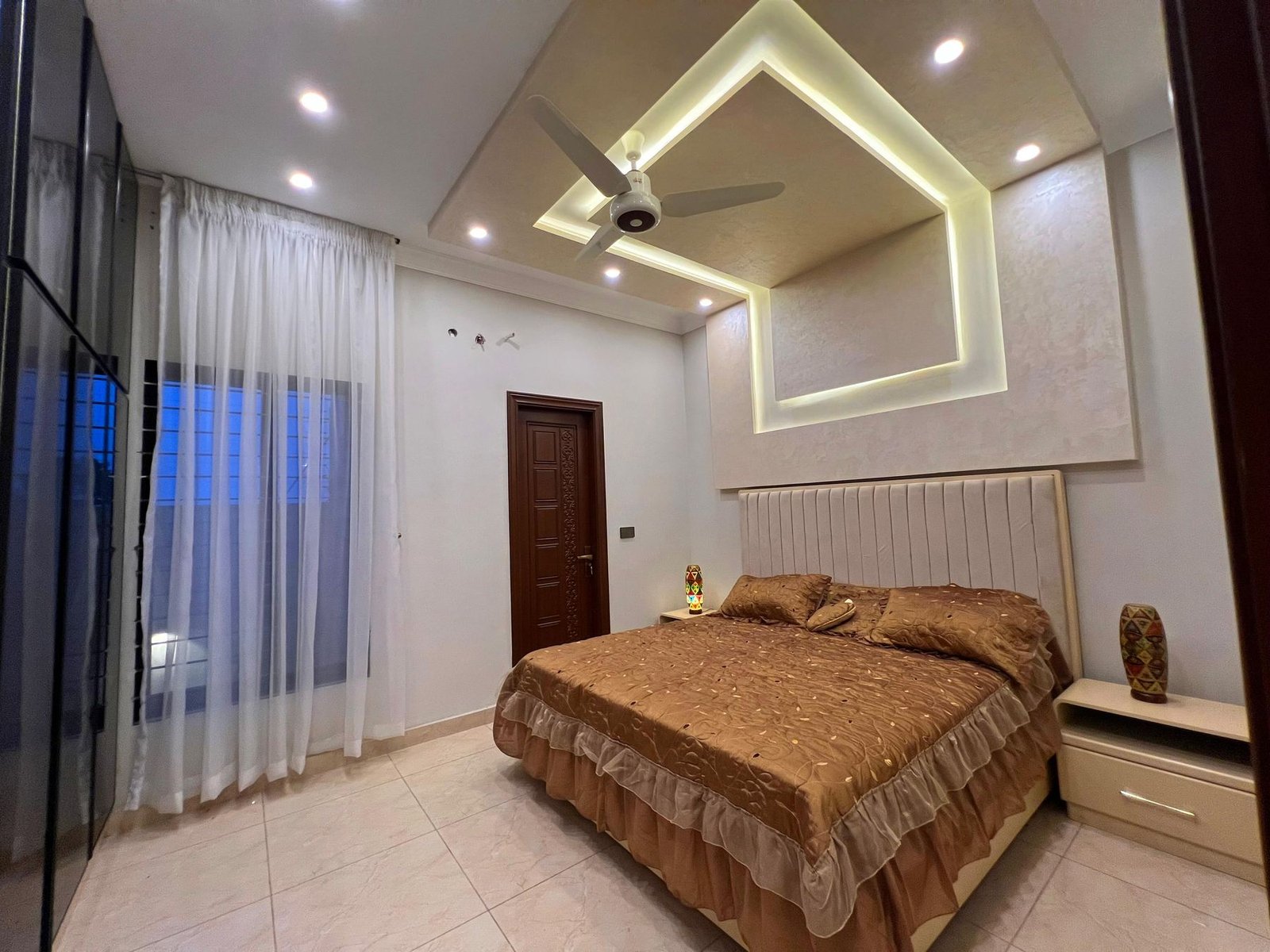 Bedroom with geometric LED ceiling detail
